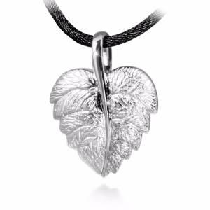 Silver cremation pendant shaped like a detailed leaf, featuring textured veins and a polished central stem, shown suspended from a black cord.