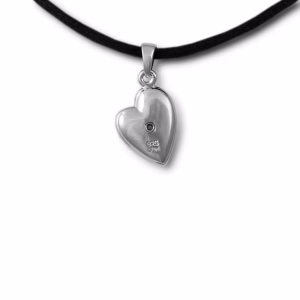 Backside of a polished silver heart-shaped cremation pendant featuring a small central screw opening for ashes and a subtle “925” sterling silver marking, shown hanging from a black cord.