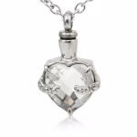 Clear heart-shaped cremation necklace with faceted glass held by detailed silver prongs on a silver chain.