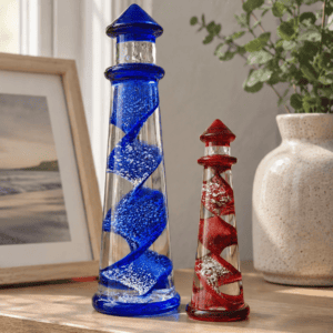 Colorful cremation art glass lighthouses with spiraled design in blue and red.