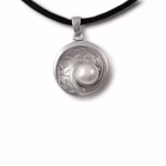Silver cremation pendant with a raised pearl nested in a textured circular design