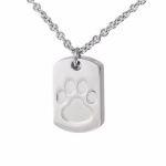 Close-up image of a stainless steel dog tag–style cremation pendant featuring an engraved paw print design on the front.