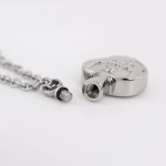 Silver Claddagh cremation necklace with threaded ash compartment shown opened