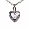 Close-up view of a silver heart-shaped cremation pendant engraved with a teddy bear design on the front, shown hanging from a silver chain.