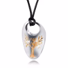 Silver teardrop-shaped cremation pendant with a polished finish, featuring a raised gold Tree of Life design on the front and suspended from a black cord.