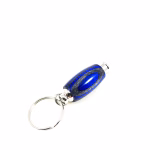 Hearthwood urn pendant shown in royal blue and charcoal laminate wood with silver metal key ring attached on white background