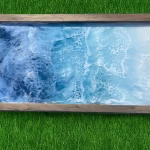 Wood-framed ocean resin memorial artwork featuring swirling deep-blue waves blending into light turquoise water and foamy white surf.