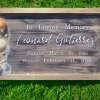 Oceanside memorial frame with a resin shoreline of blue waves and seashells on the left, and engraved text honoring Leonard Gutierrez on a wood background.