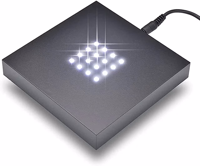 A square light display pedestal with 16 bright white LED lights.