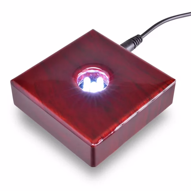 A cherry wood light base with 5 white LED lights in the middle.