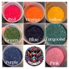 Color chart showing nine containers of crushed glass in red, orange, yellow, green, blue, turquoise, purple, and pink with the Sands of Time Memorial Art Collective logo in the center