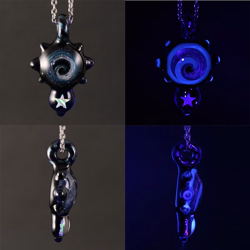 Opal Drop cremation pendant shown in studio lighting and under UV light, revealing the glowing spiral design and opal star accent on black glass