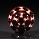 Handmade Shadow Marble with Cremation Ash featuring red and black patterned glass design shown from back view