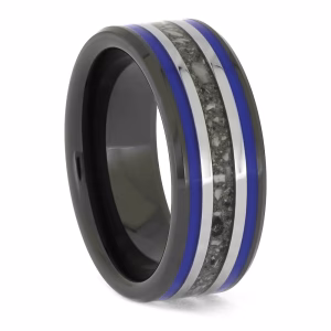 Angled side view of black ceramic memorial ring with blue enamel pinstripes and titanium inlay band containing cremation ashes.