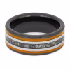 Top view of black ceramic memorial ring with orange enamel pinstripes and titanium inlay band containing cremation ashes.