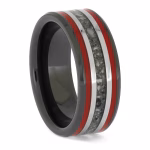 Angled view of black ceramic memorial ring with red enamel pinstripes and titanium inlay band containing cremation ashes.