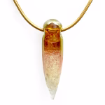 Solid glass crystal cremation pendant with visible cremation ashes inside, featuring a clear-to-amber gradient created with pure gold fume and suspended from a gold snake chain.