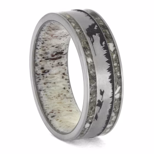 Angled view of hunting dog memorial ring with brushed silver center, engraved hunter and hunting dog scene with treeline silhouettes, cremation ash inlays on both sides, and antler interior.