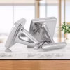 Angled side view of a pair of polished silver memorial cuff links with flat square faces and hinged backs, designed to hold cremation ashes.