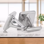 Angled side view of a pair of polished silver memorial cuff links with flat square faces and hinged backs, designed to hold cremation ashes.