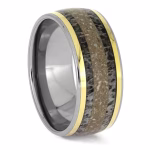 Angled view of titanium memorial ring with antler inlay, cremation ashes, and yellow gold accent