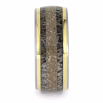Front view of titanium memorial ring with antler inlay, cremation ashes, and yellow gold accent