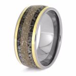 Angled view of titanium memorial ring with antler inlay, cremation ashes, and yellow gold accent