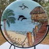 Beach Hut with Dolphins memorial glass suncatcher featuring ocean waves, palm tree, wooden pier, flying birds, and dolphins infused with cremation ash