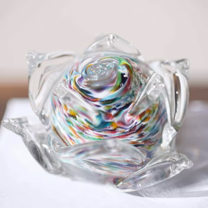 Memorial glass flower – handmade memorial glass flower with cremation ash suspended in a rainbow swirl, by Sands of Time.