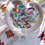 Glass Heart of Remembrance showing rainbow memorial glass with cremation ash suspended inside, by Sands of Time.