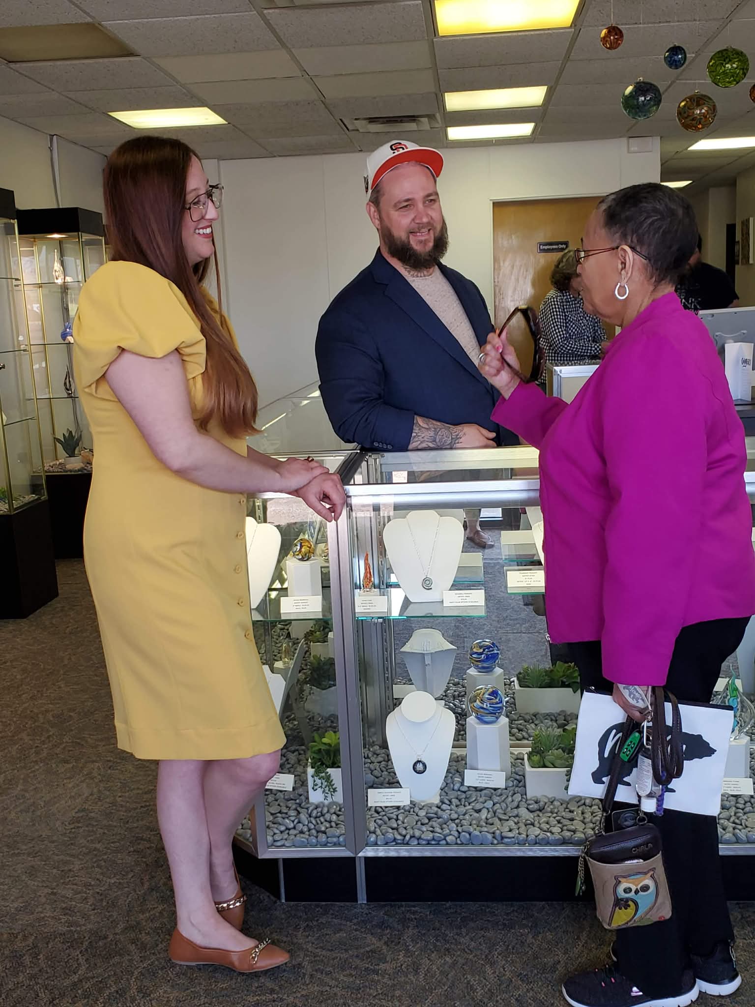 Sands of Time team member assisting a customer at the showroom display counter