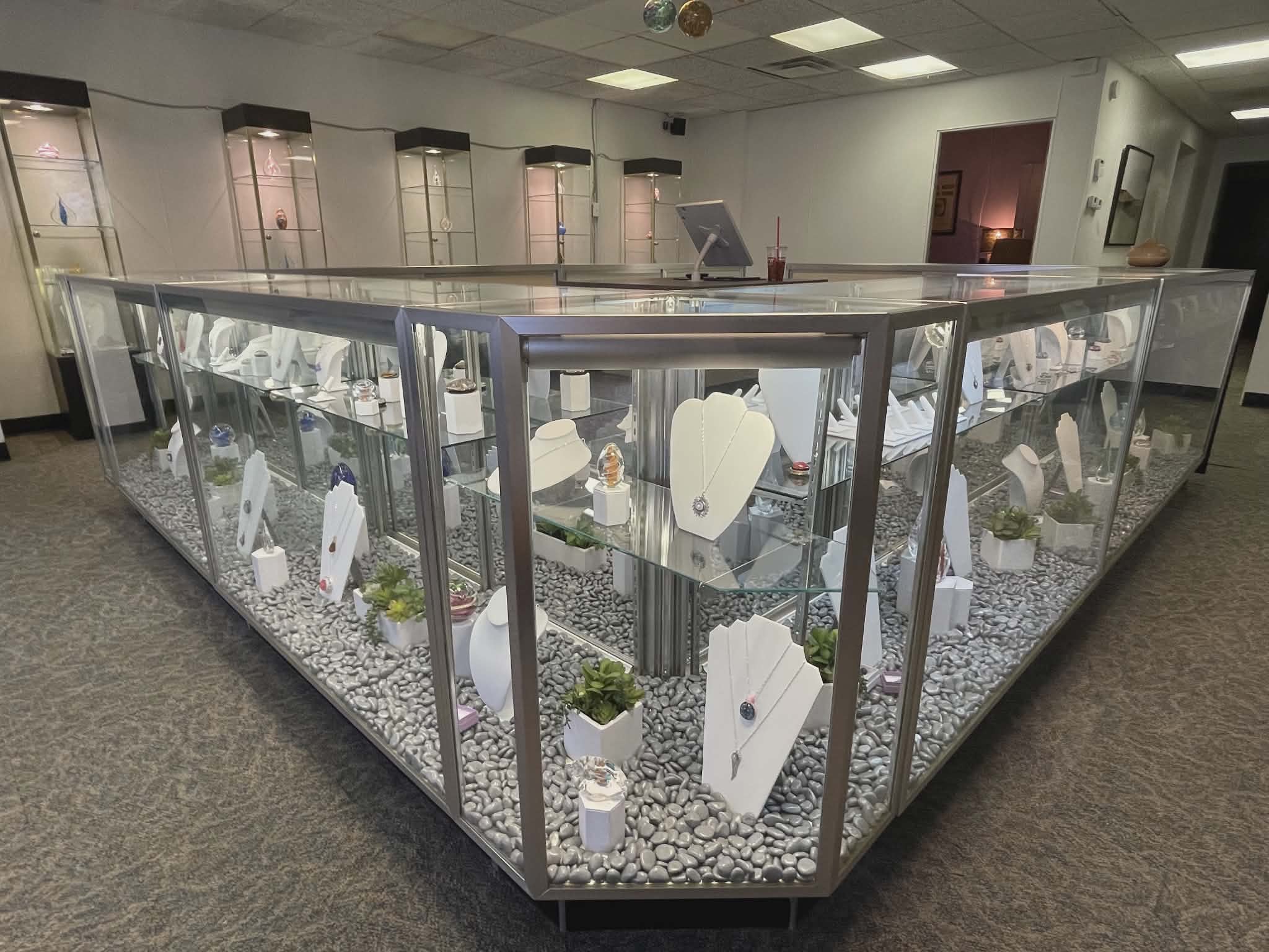 Wide view of the Sands of Time Kansas City showroom interior with illuminated display cases