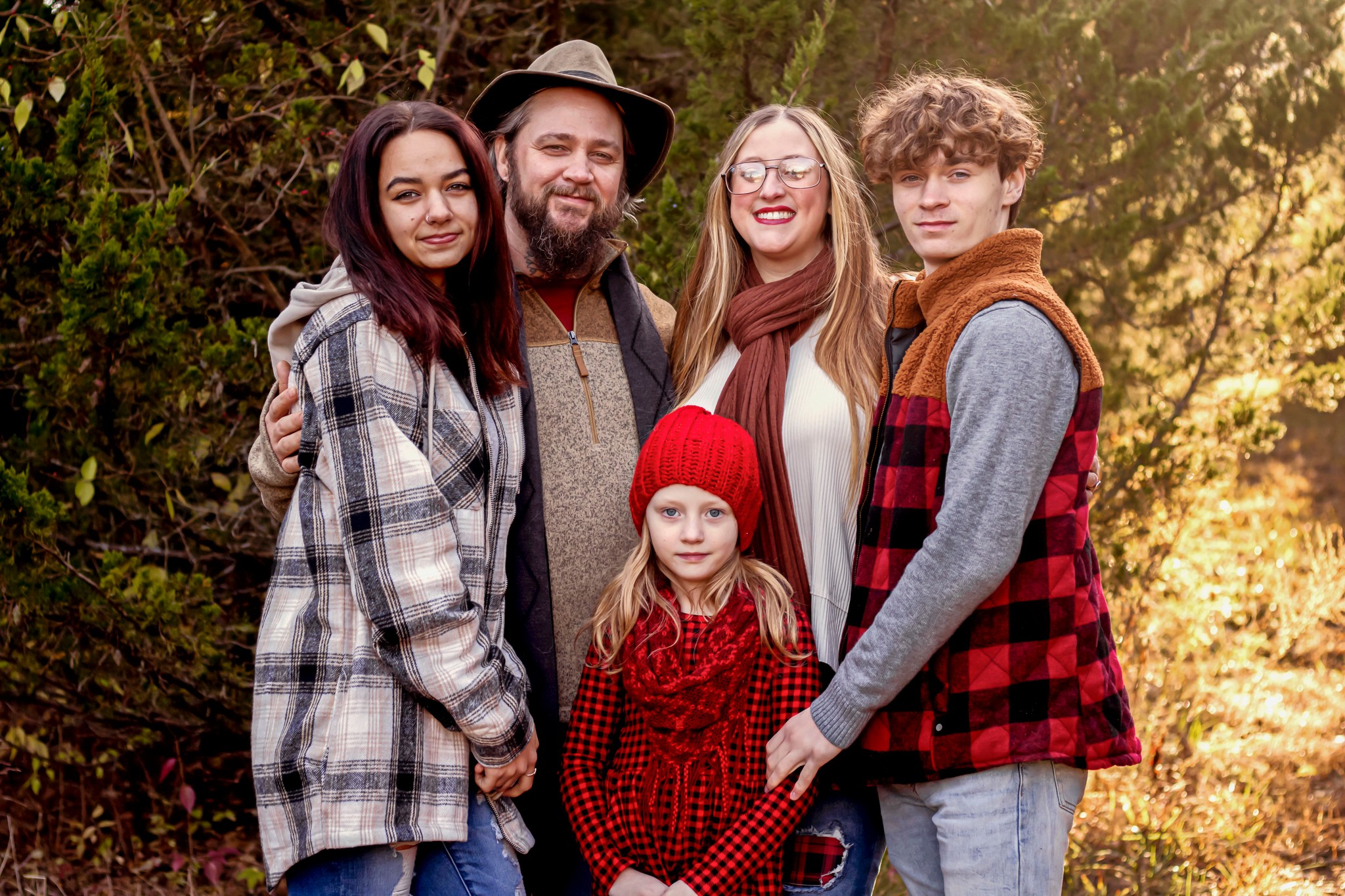 Chris Santora standing with his wife and children outdoors, founder of Sands of Time Cremation Art Glass.