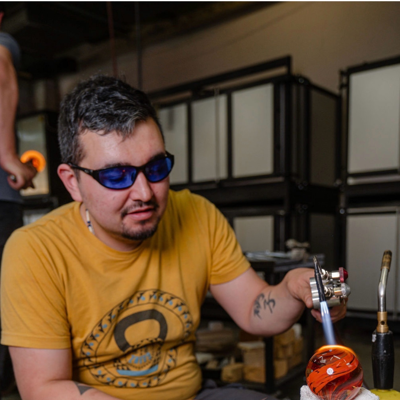 Memorial artist working in a studio environment creating handmade cremation jewelry and glass memorials