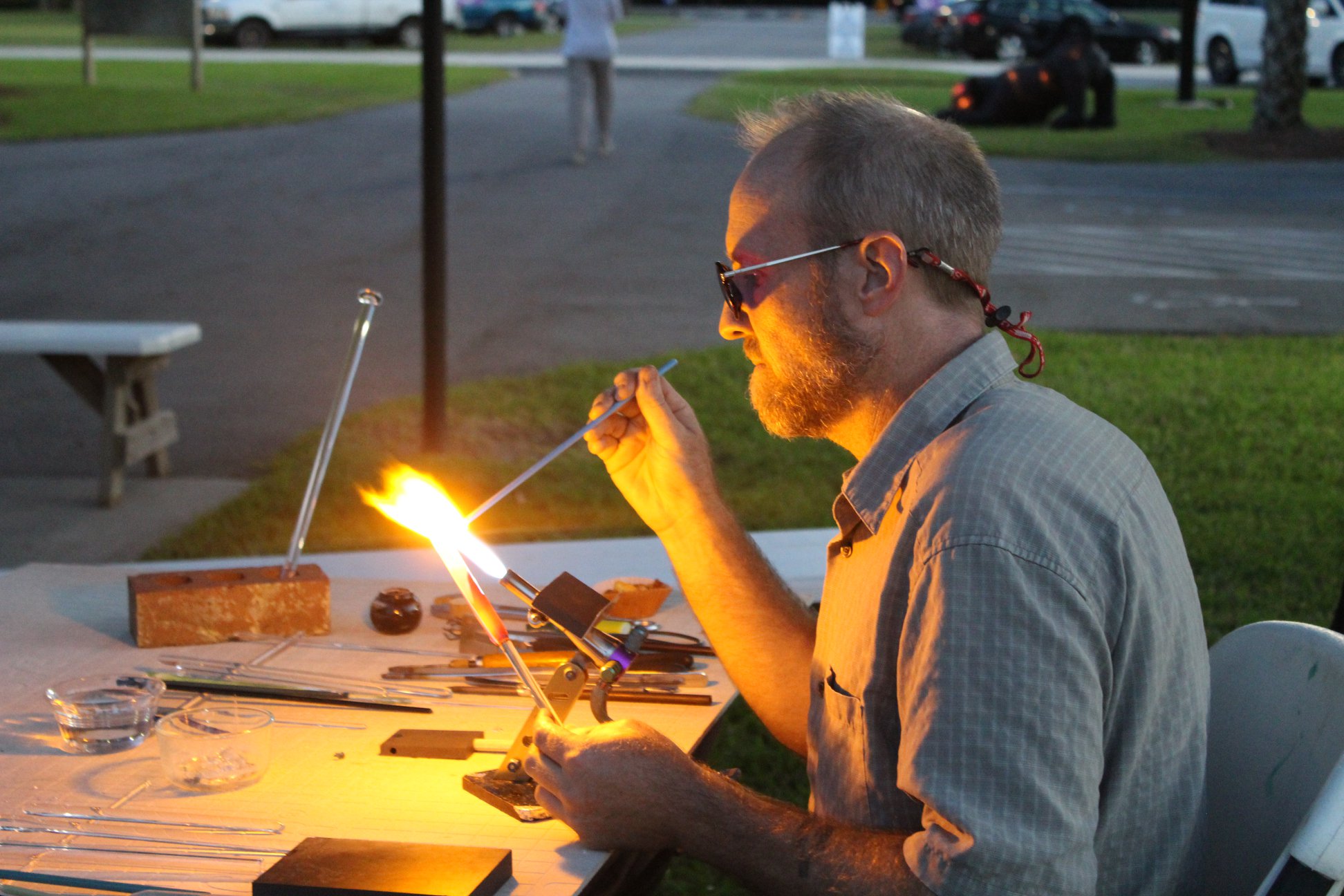 Memorial artist at work in the studio crafting cremation glass memorials with careful ash handling and skilled technique