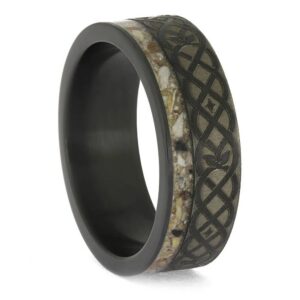Upright angled view of black zirconium cremation ring with ashes and Celtic knot engraving