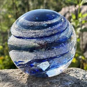Sapphire blue birthstone glass paperweight with cremation ashes in a Sparkle Swirl design