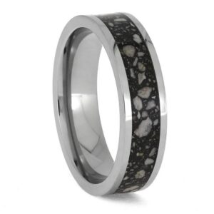 Upright angled view of polished titanium cremation ring with ashes and black enamel center inlay