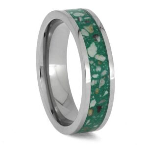 Upright angled view of titanium cremation ring with ashes preserved in a green enamel center inlay