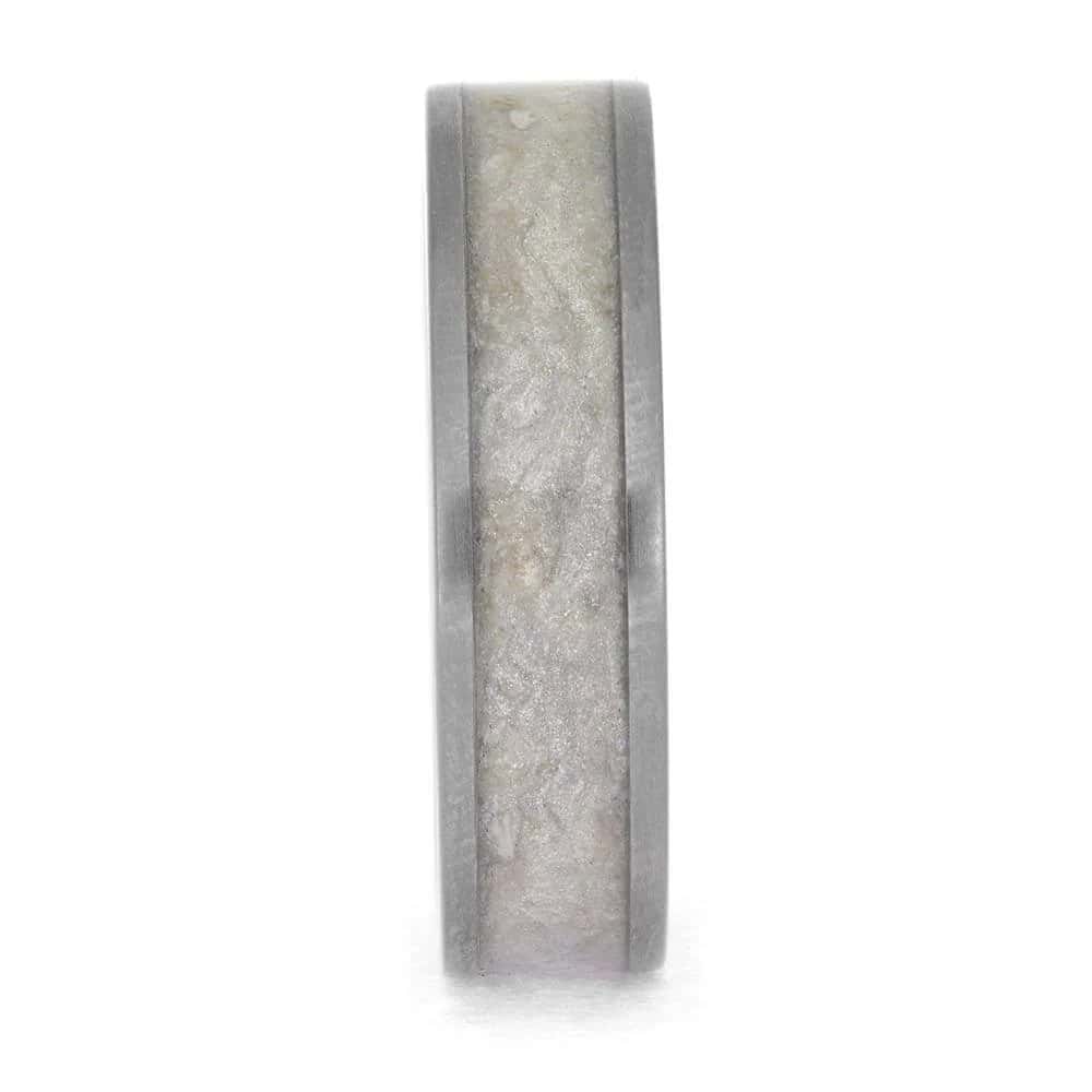 Titanium cremation ring layout with ashes and shimmering mica center inlay