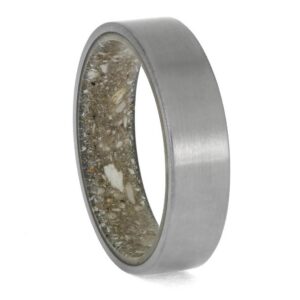 Upright angled view of matte titanium cremation ring showing ashes preserved inside the interior sleeve