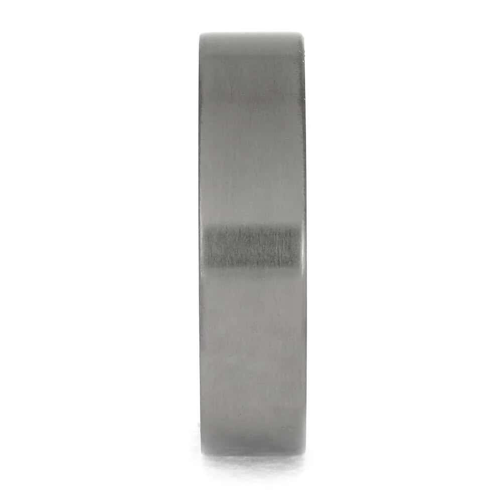 Titanium cremation ring showing cremation ashes preserved within the interior ash sleeve