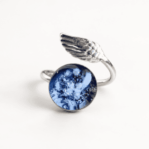Blue angel wing cremation ring with ashes sealed inside a handmade glass jewel and sterling silver wrap-around band