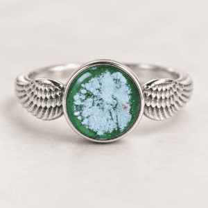 Green double angel wing glass cremation ring with ashes encased inside a handmade glass jewel and sterling silver wing band