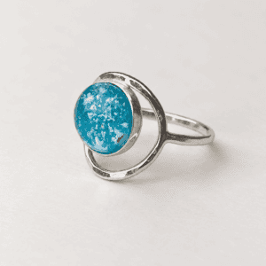 Turquoise Full Moon cremation ring with ashes encased inside a handmade glass jewel and sterling silver circular band